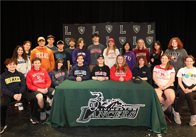  fine arts students at signing table